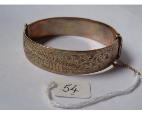 Rolled gold bangle with scroll decoration    