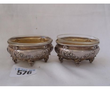Pair of French oval salts sides embossed with stylised plants.   Bracket feet. 2.5in wide. 80g ex      