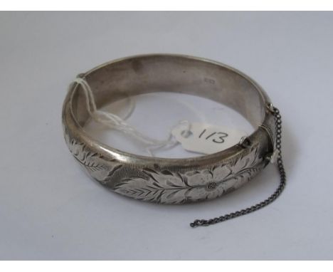 A wide chased silver bangle      