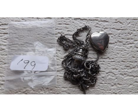 An antique silver tassel on silver chain with  silver heart locket       