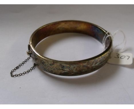A wide silver chased silver bangle     