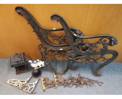 A selection of cast iron items to include two bench ends, an Oriental style lantern, a bell, ducks display and a selection of