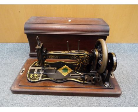 A vintage Jones Family Sewing Machine in wooden case.