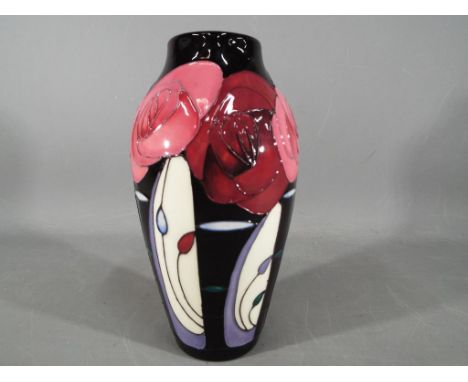 Moorcroft Pottery ceramic vase decorated in Bella Houston pattern with maker's mark to the base and measuring approximately 2