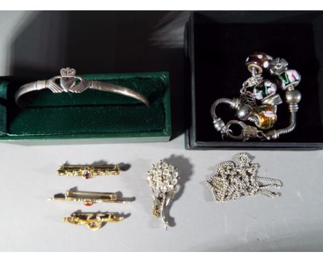 A vintage, stone set horseshoe bar brooch, stamped 9ct, a Claddagh bangle stamped 925, costume jewellery and similar.