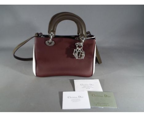 A good quality leather triple coloured small day bag marked Christian Dior Paris Made in Italy with Dior keyring logo attache