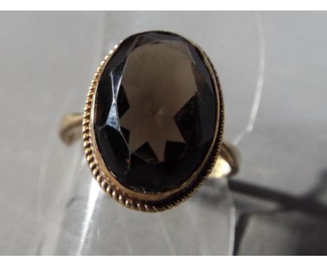 9 ct - a 9 carat gold ring set with smoky quartz, size P and a half, approximate weight 3.9 grams