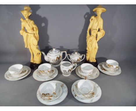 22 pieces of ceramic tableware decorated with an Asian theme displaying Geisha girl in base of cup and a pair of Asian figure