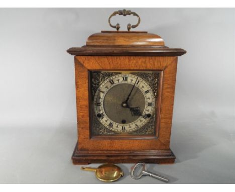 A Westminster bracket clock with Perivale movement, Roman numerals to the dial, with key, pendulum and case key.
