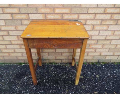 A wooden vintage school desk with metal hinged lid opening to reveal the internal storage. and ink pot, 76 cm x 62 cm x 45 cm