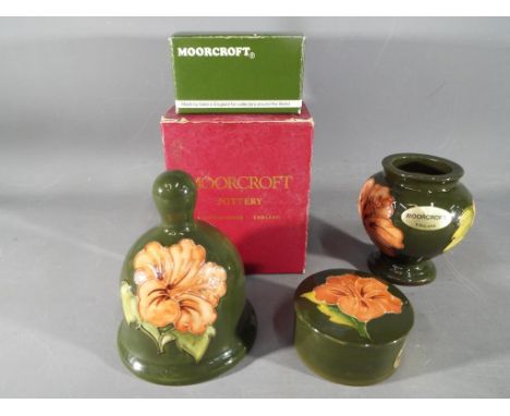 Moorcroft - Three pieces of Moorcroft Pottery decorated with hibiscus on a green ground to include a limited edition Moorcrof