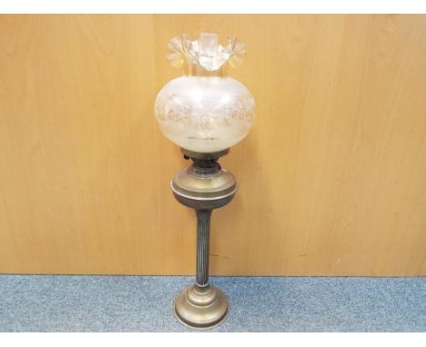 A brass oil lamp with glass shade, approximately 68 cm (h).