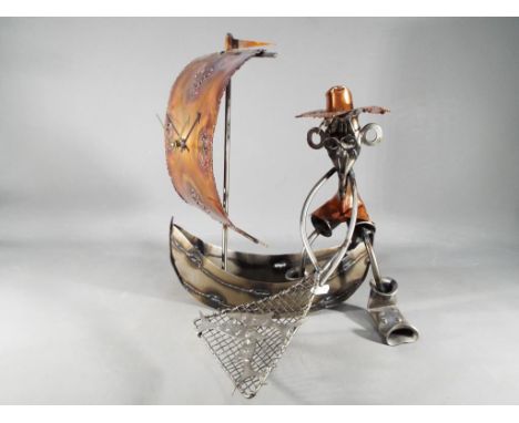 An unusual metal hand made novelty clock in a form of a Fisherman, approximate height 34 cm x 28 cm