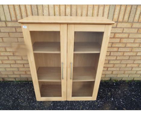 Two door book shelf approximate height 115 cm x 93 cm.