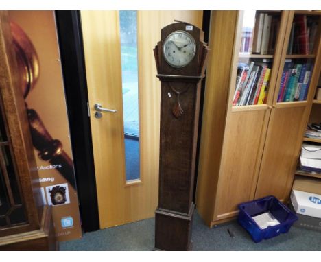 A wooden oak Grandmother clock with key and pendulum.