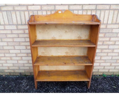 A wooden storage book shelf approximate height 126 cm x 95 cm x 34 cm