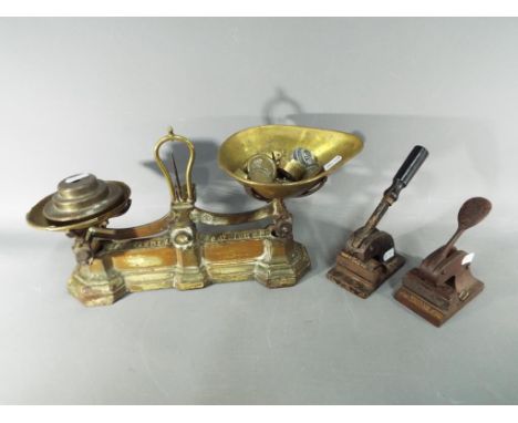 A set of W &amp; T Avery scales with weights and two vintage hand presses. [3]
