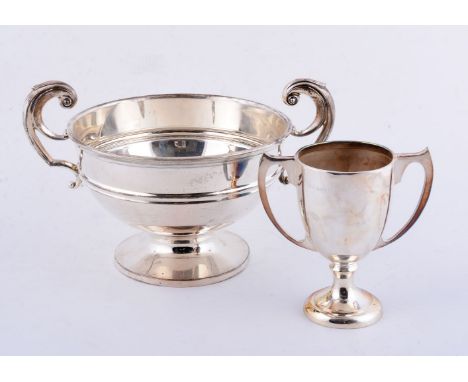 Two silver twin handled trophy cups, the larger by William Aitken, Birmingham 1909, 15cm (6in) high; the smaller by William D