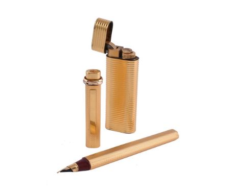 Cartier, a gilt metal fountain pen, with engine turned decoration, the cap with a trinity band and clip, cartridge filling sy