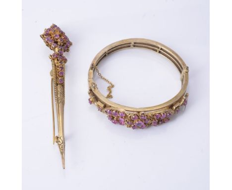 A pink sapphire bangle, the hinged bangle set with clusters of circular cut pink sapphires, 5.2cm wide; and a pink sapphire b