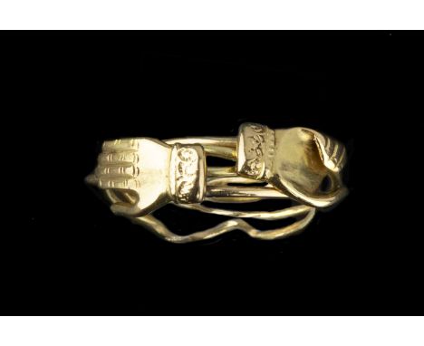 A puzzle ring, with four interlocking wirework bands, two applied with hand motifs, engraved, finger size N, 4g gross