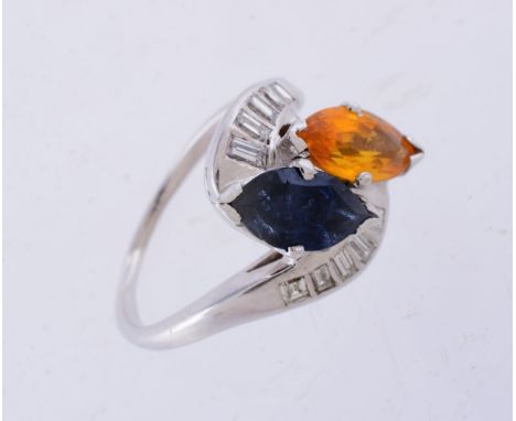 A sapphire, orange sapphire and diamond ring, the pear cut sapphire and orange sapphire in a crossover setting, with baguette
