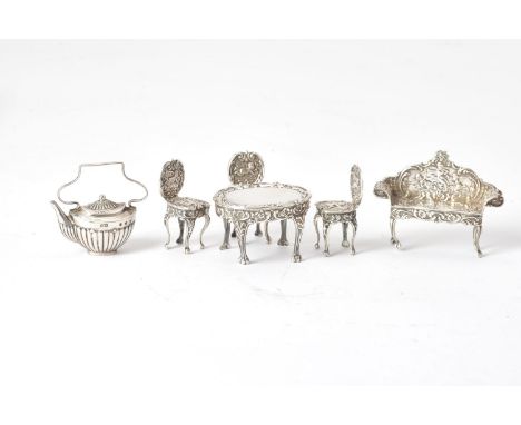 A collection of silver toys mainly furniture, comprsing: an embossed oval table, two side chairs and a sofa by E. J. Houlston
