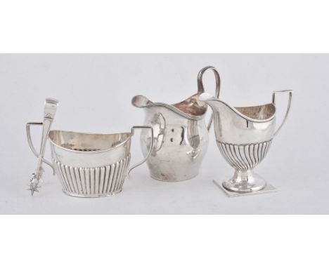 A silver swollen oval cream jug by Nathan &amp; Hayes, Chester 1910, in George III style; a Victorian wrythen pedestal exampl