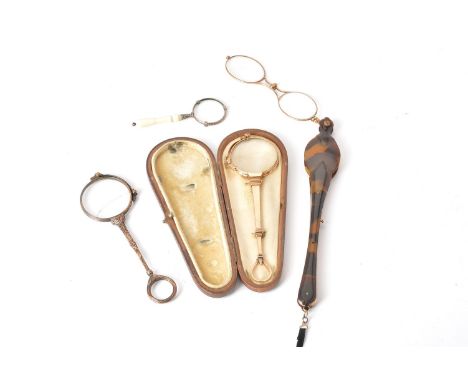 ϒThree lorgnettes and a magnifying glass, the longest tortoiseshell covered gilt metal, 18.5cm (7 1/4in)long; another gilt me