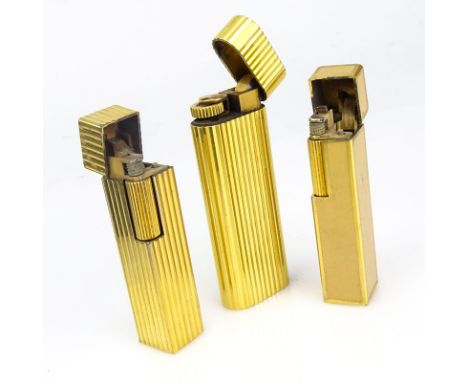 Three (3) Vintage Cartier Gold Plate Butane Cigarette Lighters, One with Lacquer. Two signed Cartier Japan, One Cartier Paris