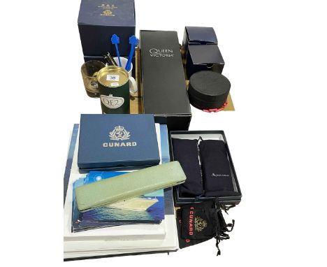 Collection of Cunard memorabilia including Halcyon Days, Queen Victoria red wine, luggage tags, etc.