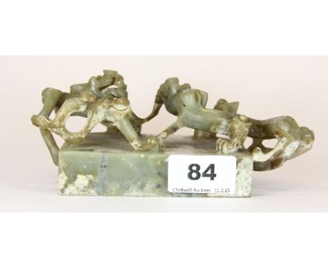 A superb early Chinese carved jade scroll weight decorated with 2 dragons fighting 18cm x 9cm x 7cm Est. £500 - 700