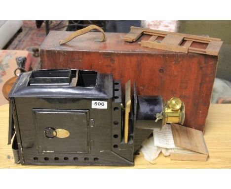 A lantern slide projector and case with 2 spare curved glass lenses