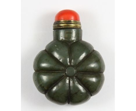A Chinese carved dark green jade snuff bottle with a gilt and coral stopper H 6.5cm
