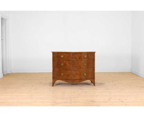 A George III mahogany serpentine dressing commode, c.1790, the top with boxwood strung edges above three graduated drawers, t
