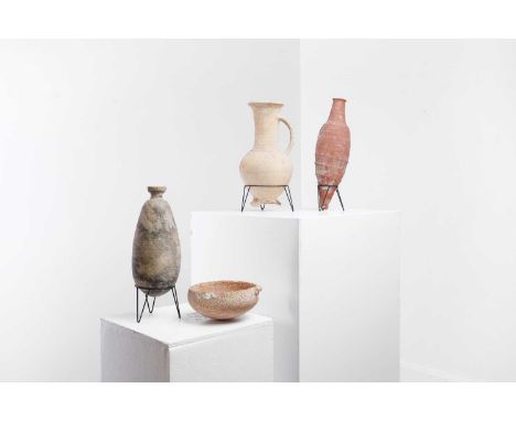 A group of pottery items, comprising:two amphora-type bottles, on metal stands,20 and 26cm high,a bowl, with a lug handle, on
