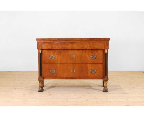 An Empire walnut, ebonised and parcel-gilt commode, early 19th century, Italian, with a rectangular top, above three long dra