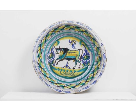 A large tin-glazed earthenware 'lebrillo' basin, 19th century, Spanish, in the Trianan style, painted in greens and yellows w