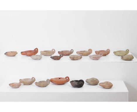 A group of Roman terracotta oil lamps, comprising variously sized examples, some with erotic decoration, largest 9.5cm wide12