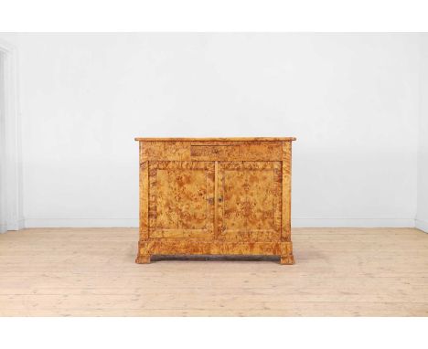 A Karelian birch commode, c.1830, Northern European, with a drawer and cupboards, on shaped bracket feet,120cm wide44cm deep9