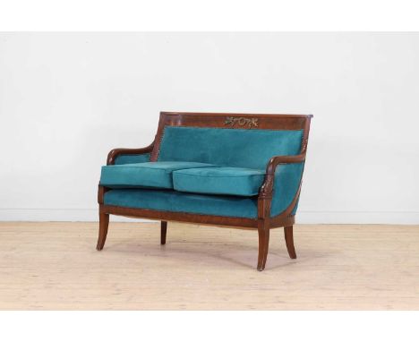 An Empire-style mahogany settee, late 19th century/early 20th century, French. the curved rail with a gilt-metal cherub and g