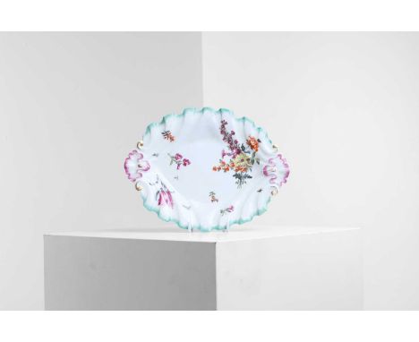 A Chelsea porcelain 'silver-shaped' dish, c.1750s, of rococo shell shape, decorated with a floral spray, sprigs and gilt scro