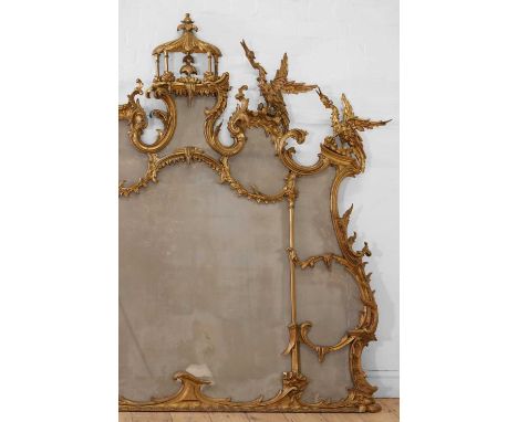 A George III-style carved giltwood overmantel mirror,  19th century, in the Chippendale taste, with elaborate scrolling rocai