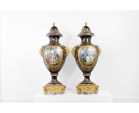 A pair of large Sèvres-style porcelain vases and covers, late 19th/early 20th century, French, each vase of baluster form wit