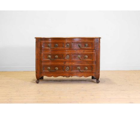 A Louis XV provincial walnut commode, mid-18th century, French, of serpentine outline, the moulded top above three panelled l