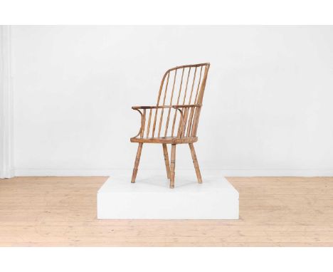 An ash and fruitwood Windsor chair, late 18th century, West Country, with a high stick back above a shaped seat, raised on ri
