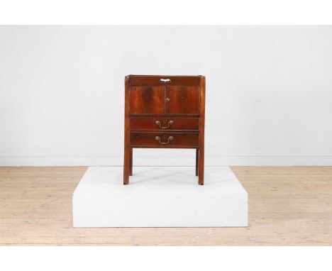 A mahogany pot commode, early 19th century, with a tray top above a pair of drawers and a cupboard, raised on chamfered squar