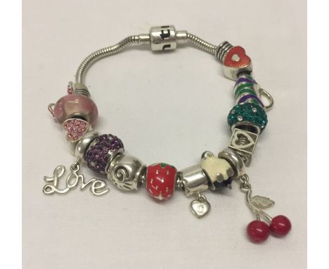 Truth silver snake charm bracelet with 14 charms of different designs.