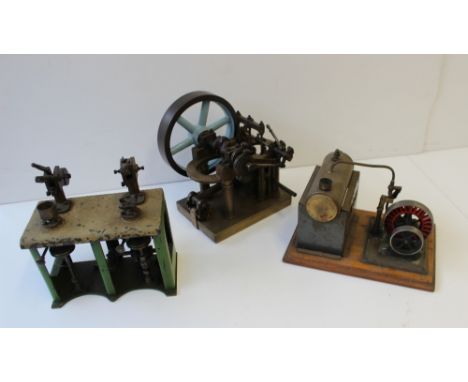 A Live Steam Stationary Engine consisting of horizontal brass boiler and flywheel on a wooden base, together with two working