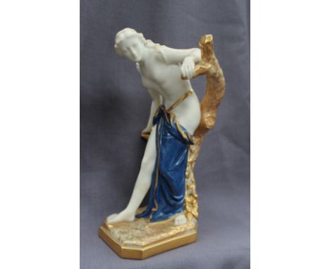 A Royal Worcester porcelain and Parian figure of a semi nude maiden, holding on to the branches of a tree and draped in blue 